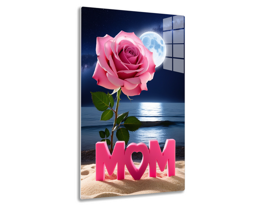 A vibrant pink rose blooming against a starry night sky with a full moon reflecting on calm waters, accompanied by the text "MOM" in pink letters on a sandy beach.
