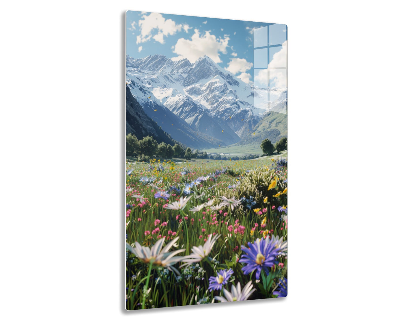 Scenic view of majestic snow-capped mountains towering over a vibrant alpine meadow blanketed with a profusion of colorful wildflowers in full bloom under a blue sky with fluffy white clouds.
