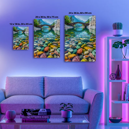 Breathtaking view of a stone bridge arching over a crystal-clear river, framed by towering mountains and lush greenery, with vibrant, colorful pebbles adorning the river bed.
