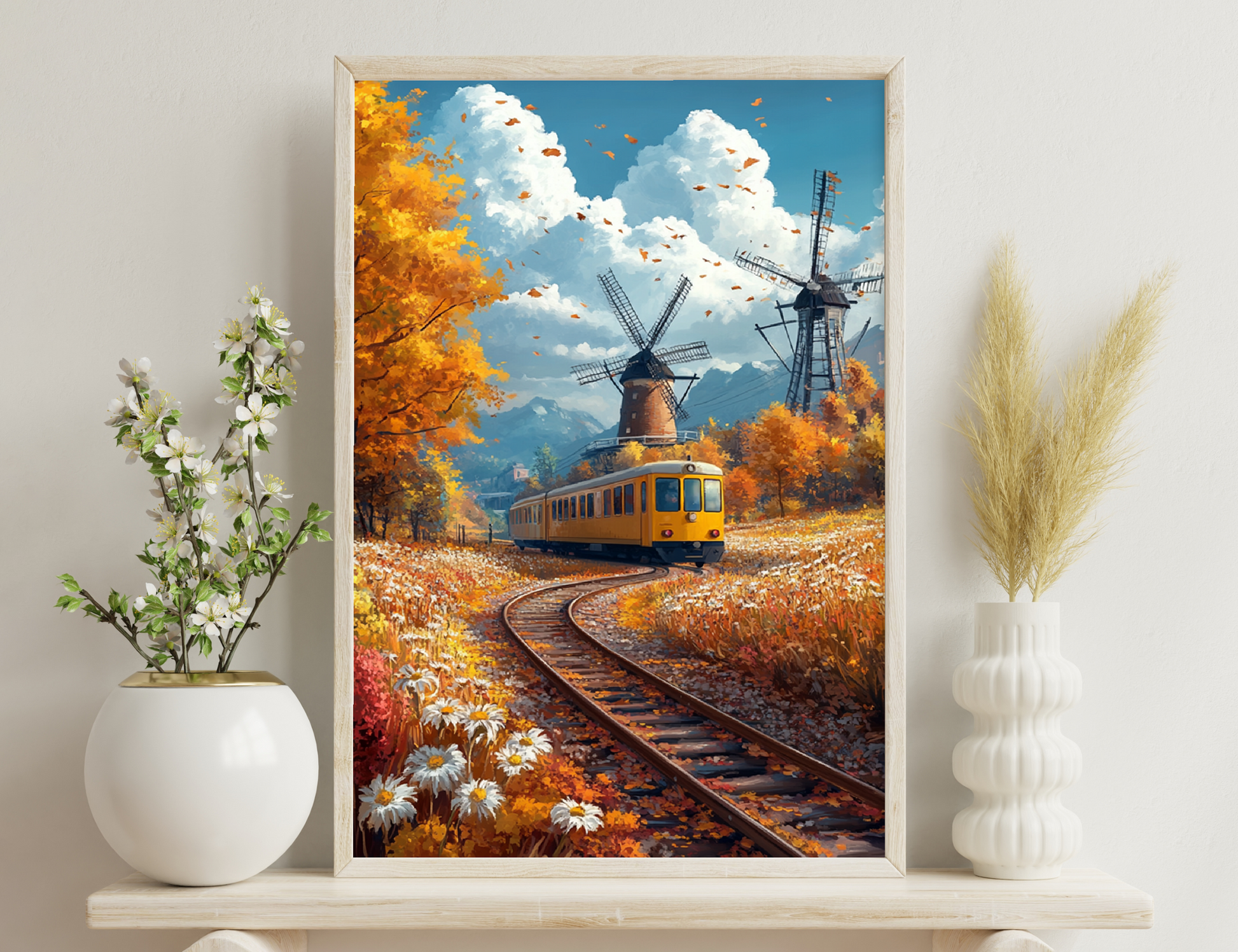 An autumn landscape with a yellow tram on train tracks, surrounded by tall windmills and golden trees with falling leaves against a cloudy blue sky and mountains in the background.
