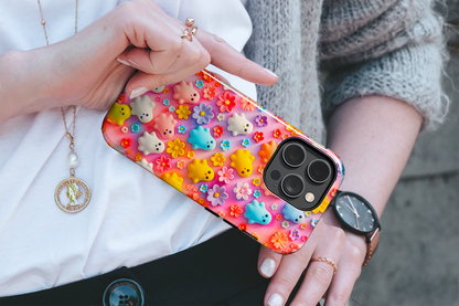 Ghoulish Garden (iPhone Case 11-15)Elevate your iPhone's protection and style with RimaGallery's Playful ghost characters amidst a floral backdrop on a bright case, featuring dual-layer defense and a RimaGallery