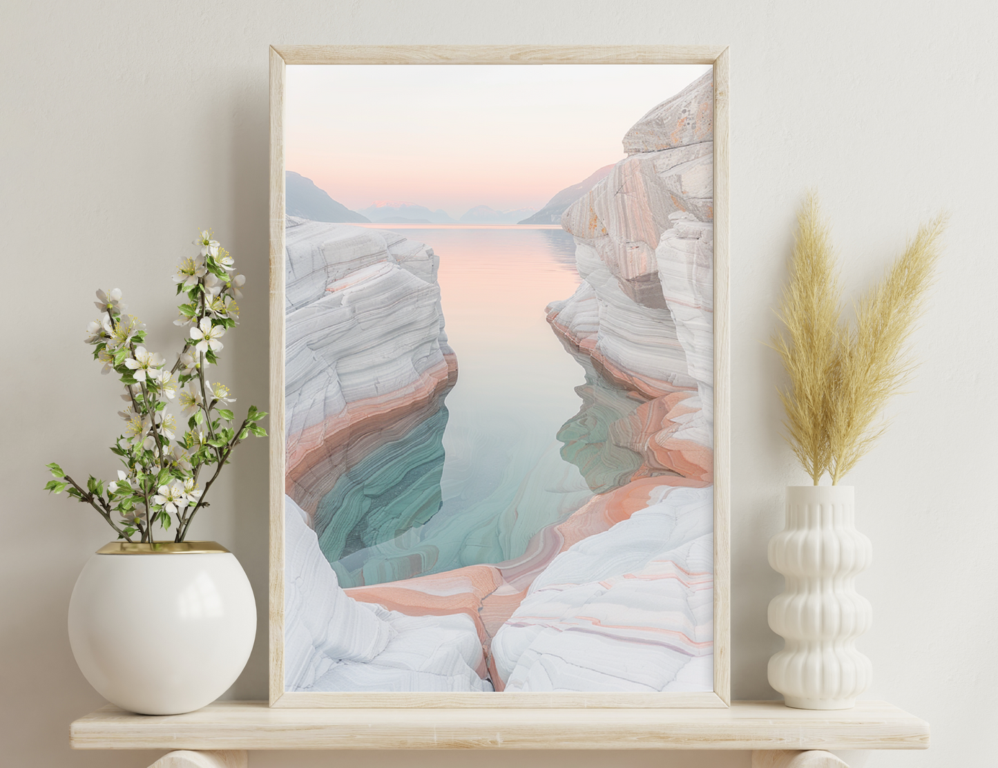 Lake surrounded by colorful striped rock formations reflecting in still water at sunset or sunrise.
