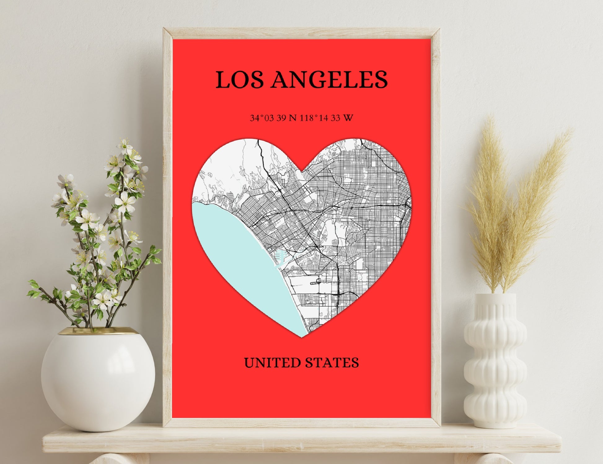 Los Angeles city map in the shape of a heart, with coordinates showing the location, against a red background.
