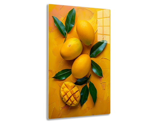 Ripe mangoes with green leaves arranged on a vibrant orange background.
