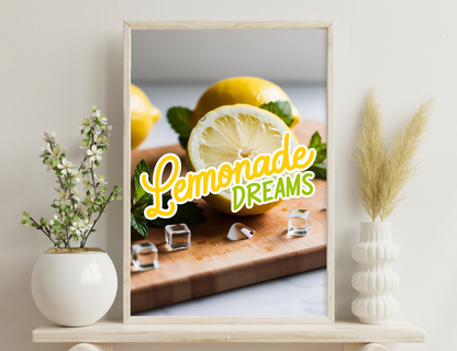 A closeup image of fresh lemons, one cut in half revealing its juicy interior, arranged with mint leaves and the text "Lemonade Dreams" on a wooden cutting board.
