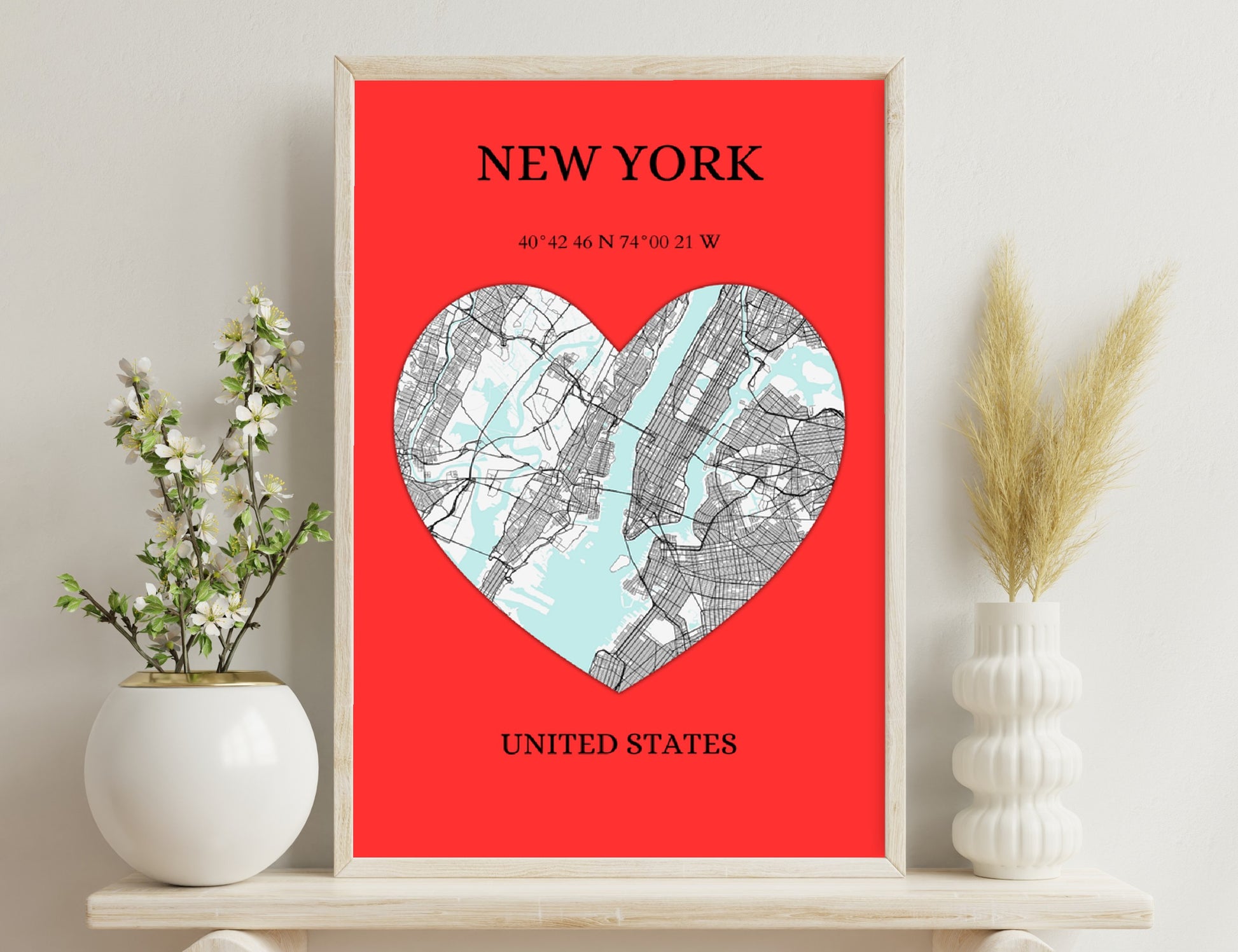 New York city map depicted in a heart shape on a red background, with geographic coordinates and 'United States' text below.
