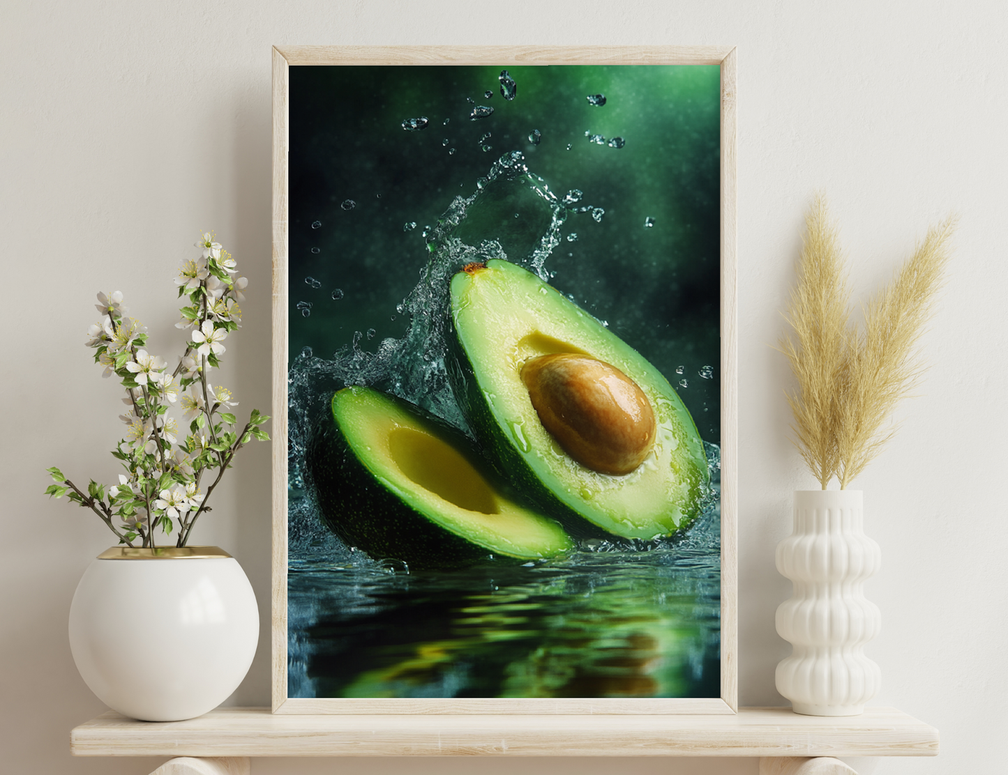 An avocado splashing into water, creating a crown of water droplets surrounding its sliced open flesh revealing the bright green meat and large brown pit inside.
