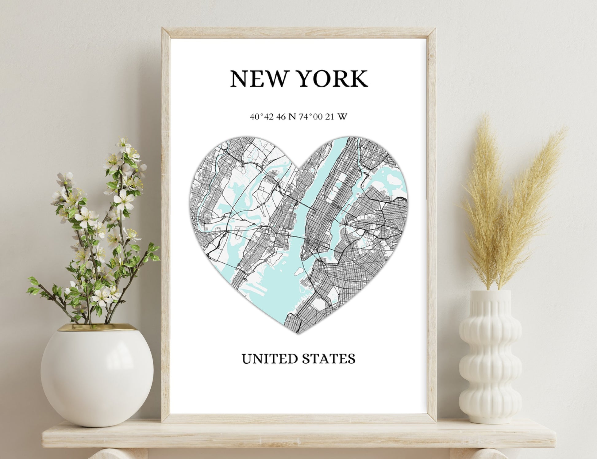 Heart-shaped map of New York City, with streets in black lines over a blue water layout, displaying geographic coordinates of 40°42'46"N 74°00'21"W, title reads "NEW YORK UNITED
