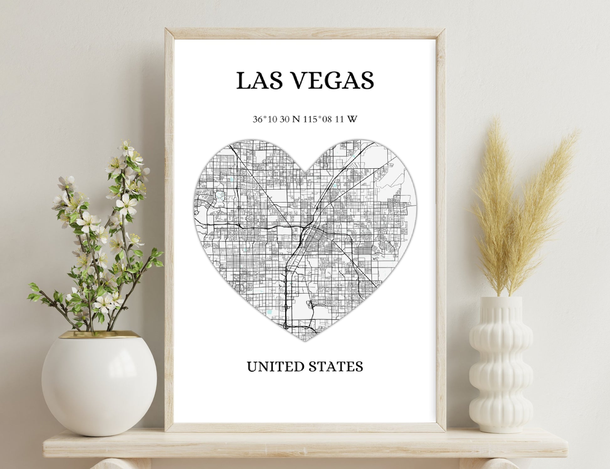Las Vegas city map in the shape of a heart, showing the street grid layout with major roads highlighted, along with geographic coordinates and the text "United States" below.
