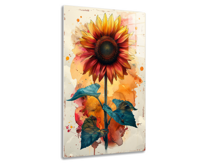 A vibrant watercolor painting of a sunflower with yellow and orange petals, a dark brown center, and teal green leaves on a colorful abstract background with splatters and brush strokes.
