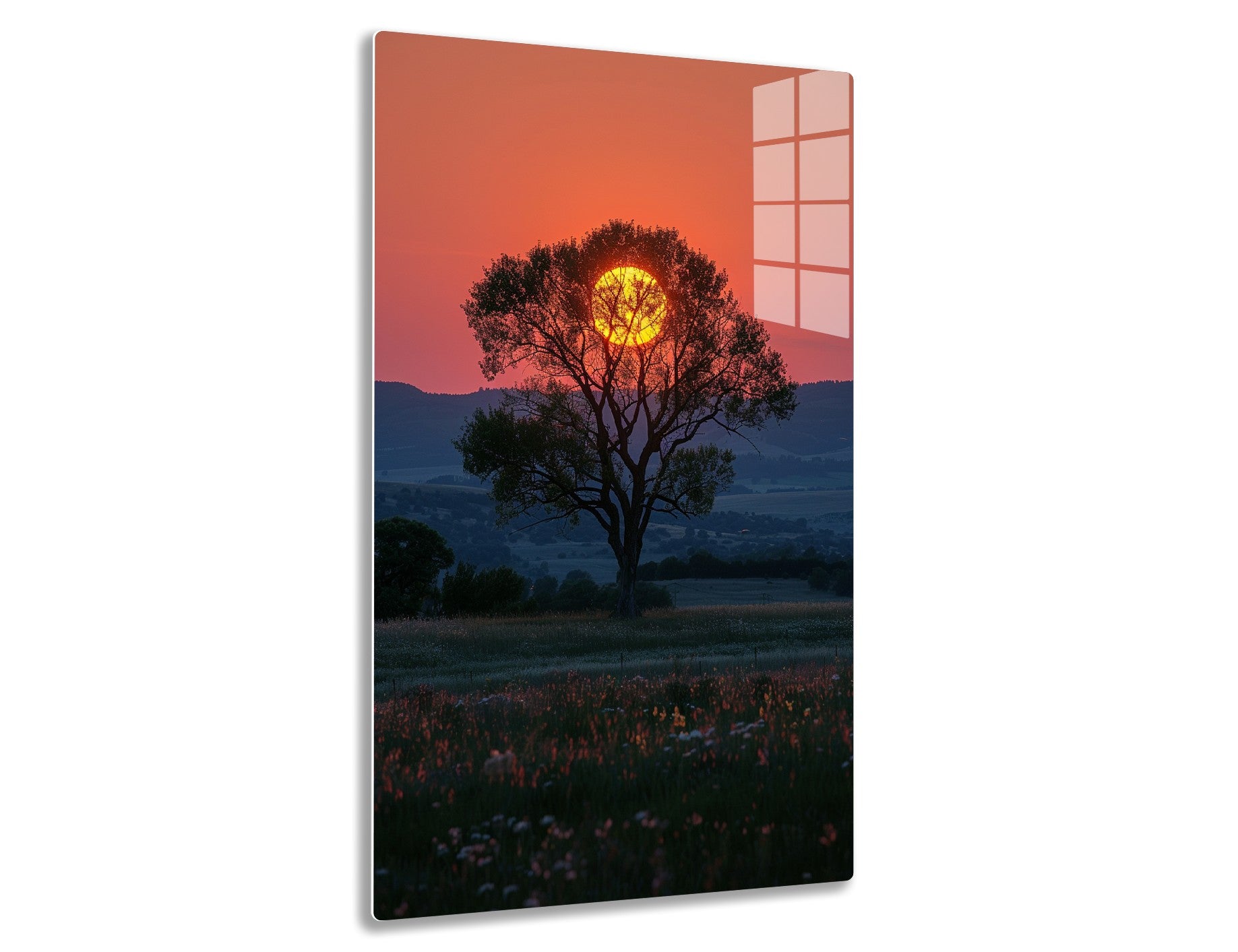 Majestic tree silhouetted against a fiery orange sunset, its branches framing the brilliant sun in a picturesque landscape with rolling hills and wildflowers in the foreground.
