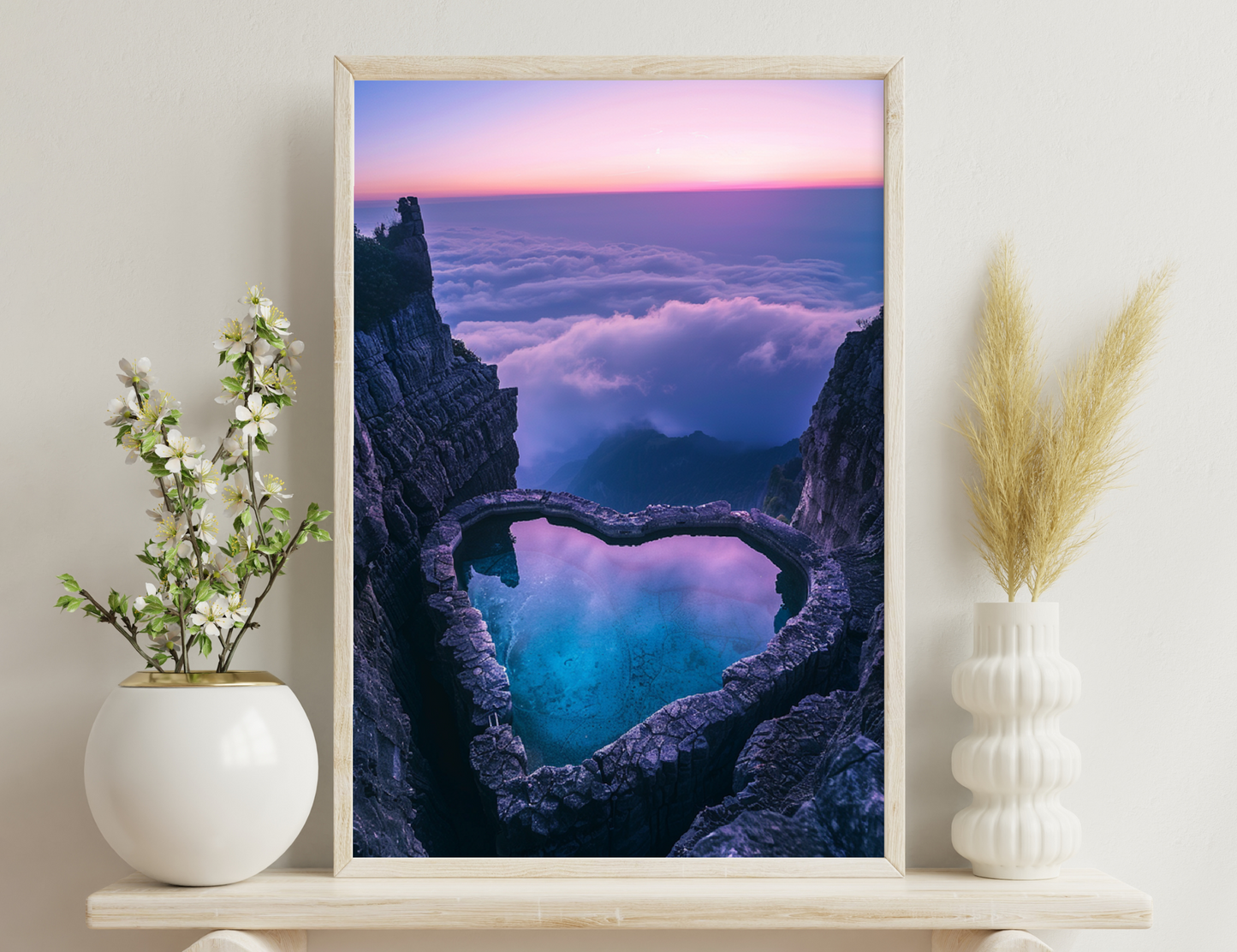 A heart-shaped turquoise lake nestled between towering rocky cliffs, with clouds filling the valley below at sunset, creating a breathtaking aerial vista.
