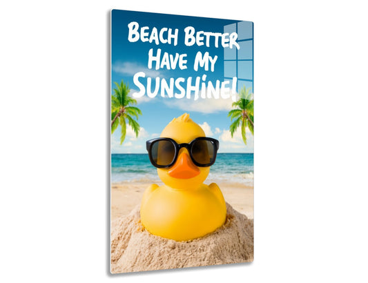 Beach scene with rubber duck wearing sunglasses on sand, palm trees and ocean in background, text reads "Beach Better Have My Sunshine!"
