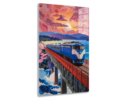 A colorful illustration of a passenger train crossing a bridge over a river against a vivid sunset sky with billowing clouds and mountains in the background.
