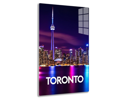Toronto skyline at night with the iconic CN Tower illuminated and the city skyline reflected in the waters, creating a vibrant and colorful scene.
