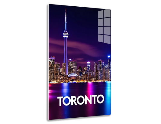 Toronto skyline at night with the iconic CN Tower illuminated and the city skyline reflected in the waters, creating a vibrant and colorful scene.
