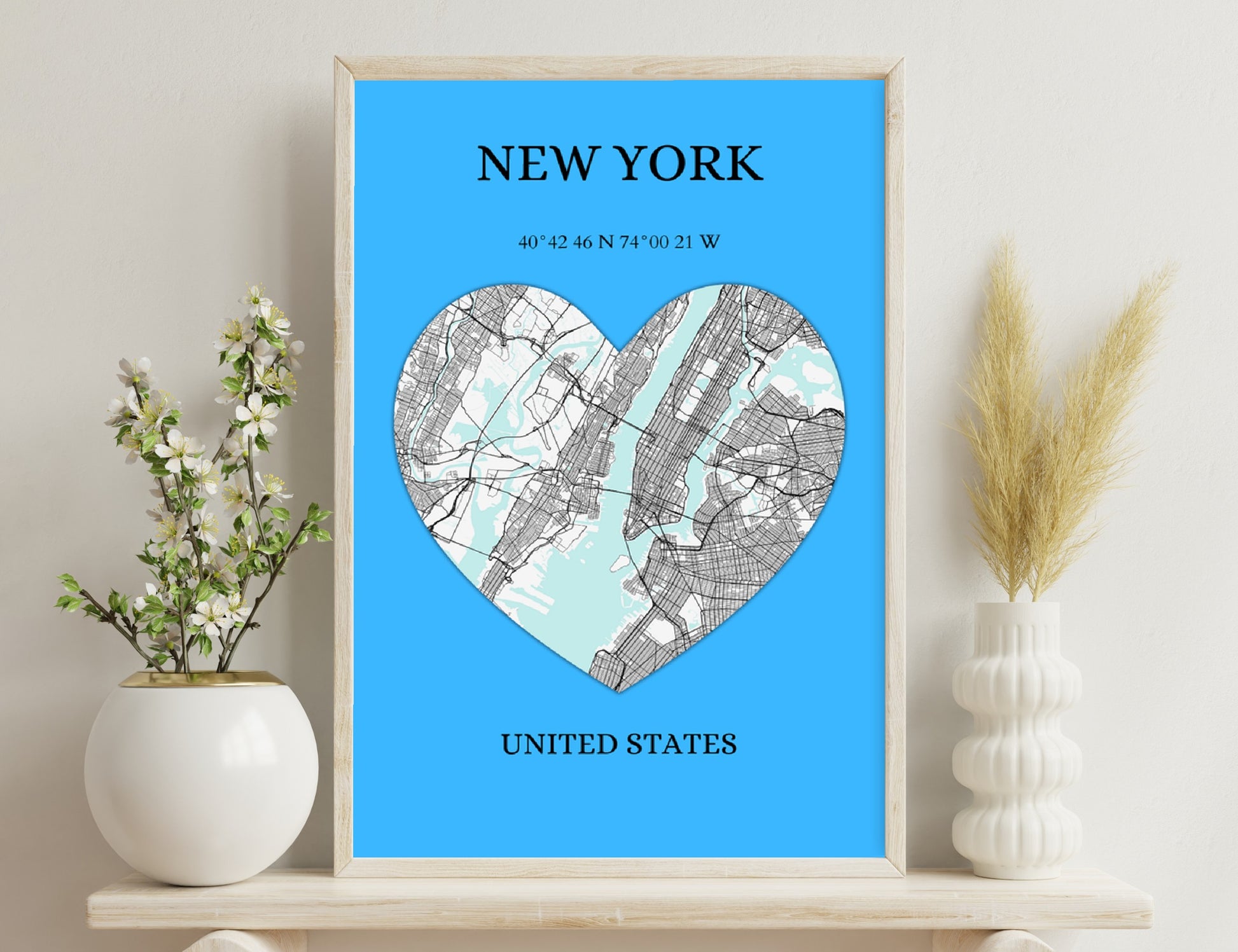 New York map in the shape of a heart, displaying streets and coordinates on a blue background
