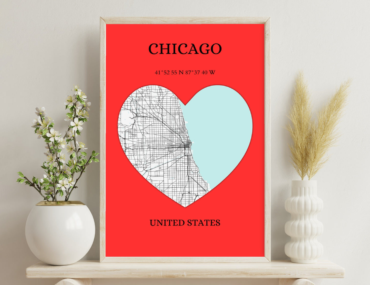 A heart-shaped map of Chicago in red and white colors, featuring a street grid overlay and the geographic coordinates of the city along with the text "Chicago, United States".
