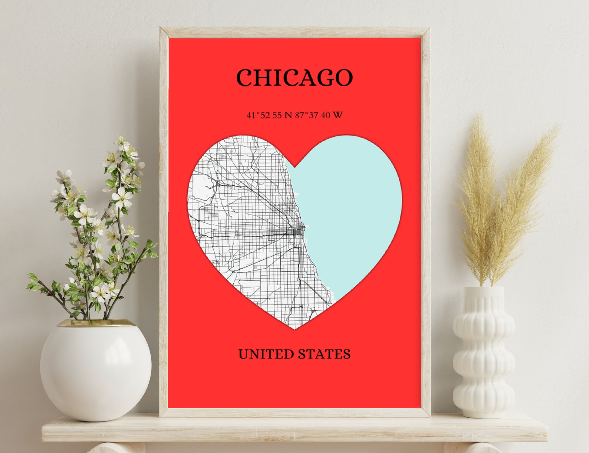 A heart-shaped map of Chicago in red and white colors, featuring a street grid overlay and the geographic coordinates of the city along with the text "Chicago, United States".
