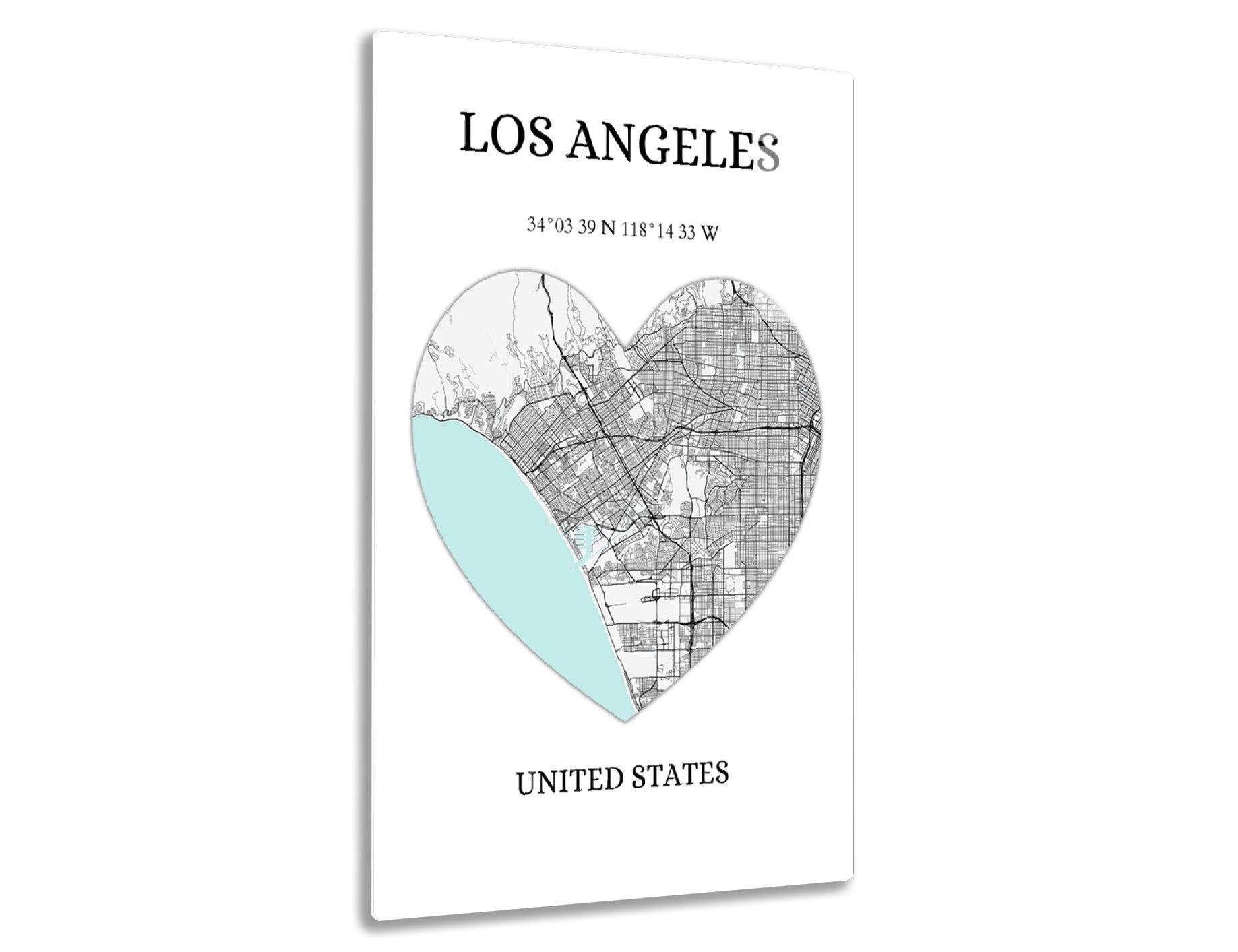Map of Los Angeles in a heart shape, showing city streets with coordinates 34°03'39"N 118°14'33"W, blue area representing the ocean
