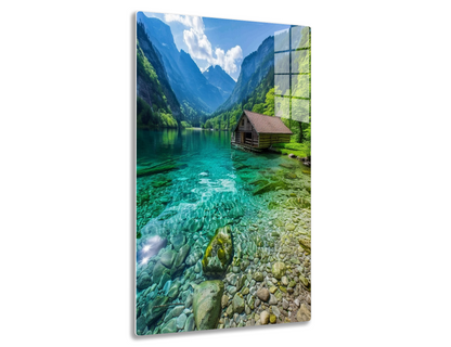 A serene mountain lake with crystal clear turquoise waters, surrounded by lush green forests and towering peaks, featuring a rustic wooden cabin on the shoreline.
