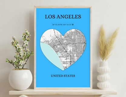 Alt text: A heart-shaped map of Los Angeles, with the street map covering the right side and the topographical map showing the mountains on the left. The city's coordinates and location are provided below the image.
