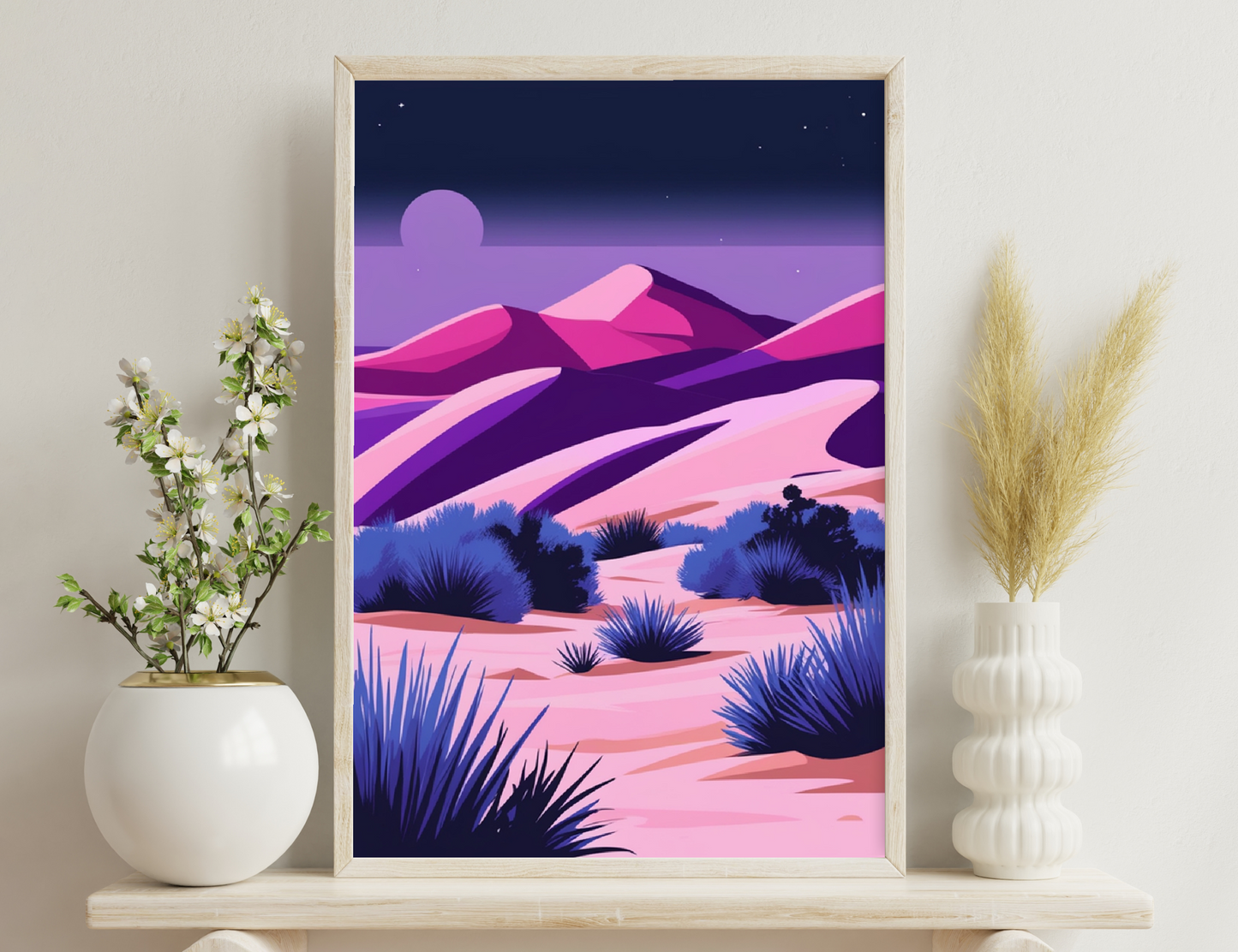 Desert landscape at dusk with vibrant shades of purple, pink and blue depicting mountains, sand dunes and silhouettes of yucca plants under a crescent moon and starry sky.
