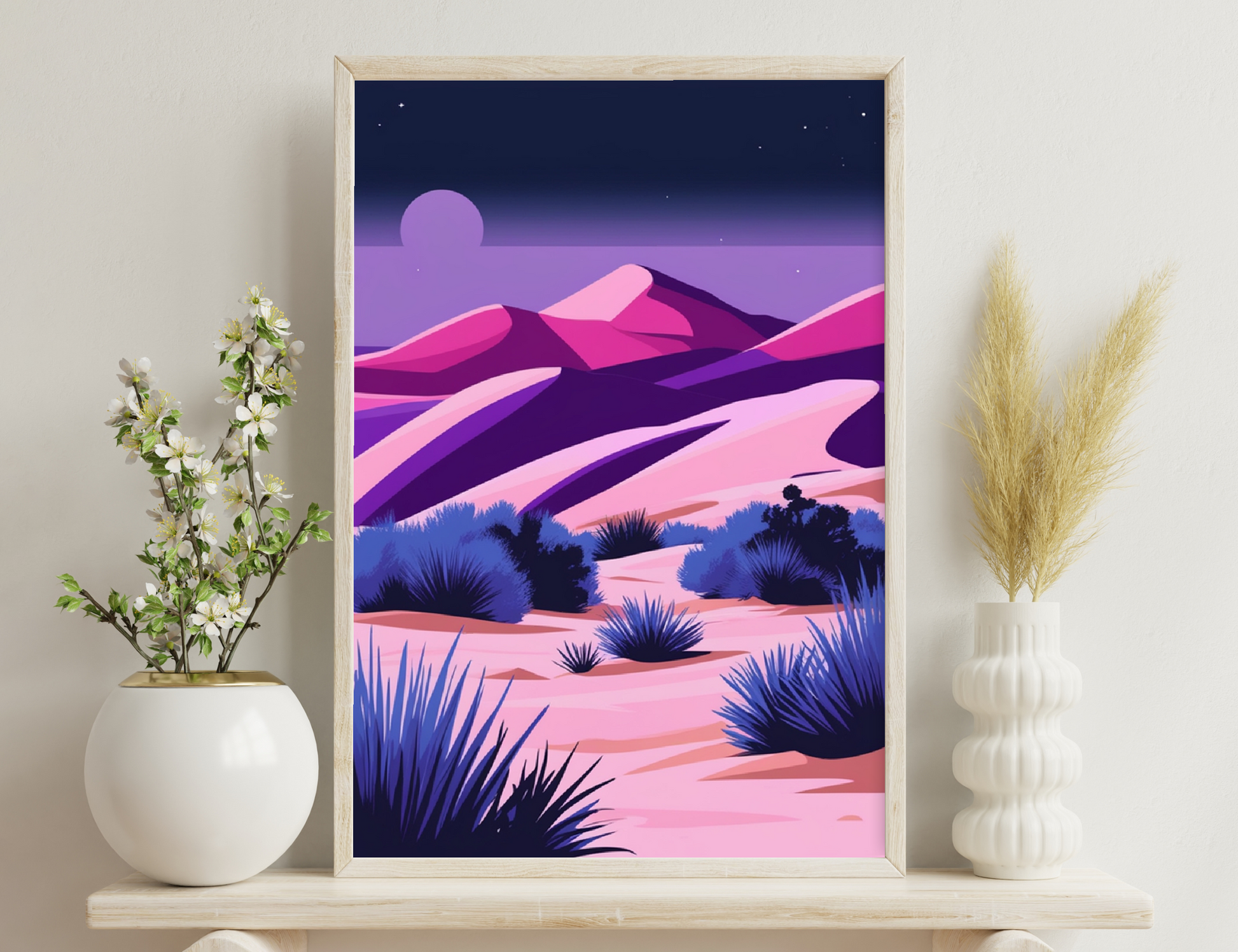 Desert landscape at dusk with vibrant shades of purple, pink and blue depicting mountains, sand dunes and silhouettes of yucca plants under a crescent moon and starry sky.

