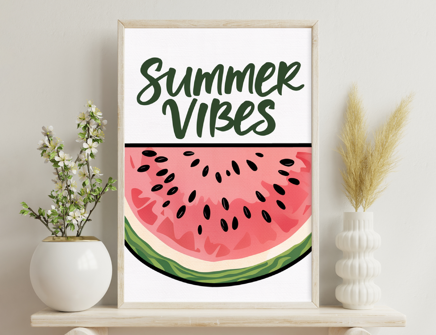 "Summer Vibes" text in green cursive with a large watermelon slice illustration showing its pink flesh and black seeds.
