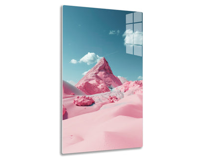 A surreal, mountainous pink landscape with a prominent pyramidal peak against a blue sky with white clouds. The snow-capped terrain appears tinted in vivid shades of pink, creating a dreamlike and otherworldly scene.

