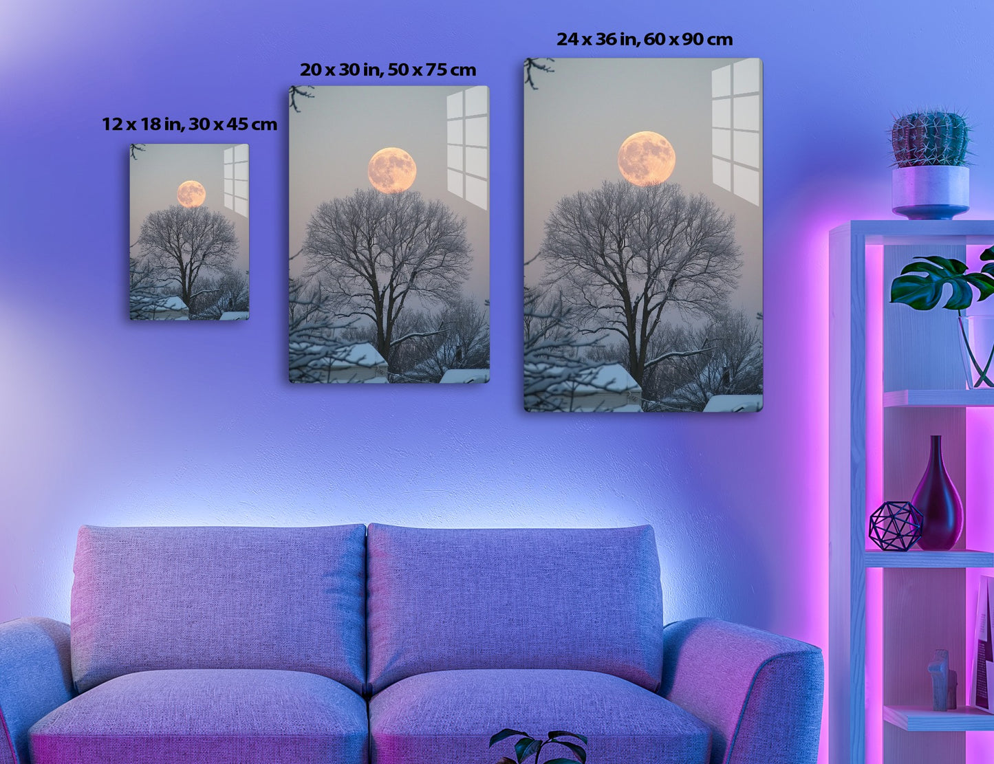 A stunning full moon rises behind bare, silhouetted trees against a twilight sky, creating a serene and picturesque winter scene.
