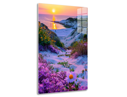 A stunning sunset over a sandy beach, with vibrant purple and yellow wildflowers in the foreground, creating a colorful contrast against the golden sun reflecting on the rippling waves.

