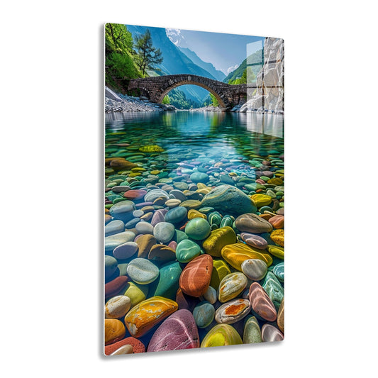 Breathtaking view of a stone bridge arching over a crystal-clear river, framed by towering mountains and lush greenery, with vibrant, colorful pebbles adorning the river bed.
