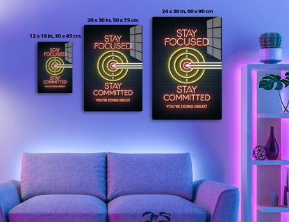 Neon sign with "Stay Focused" and target icon, along with "Stay Committed, You're Doing Great!" in motivational text and colors.
