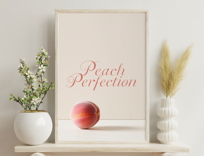 A single peach against a light background, with the text "Peach Perfection" written in a cursive reddish-pink font above the peach.
