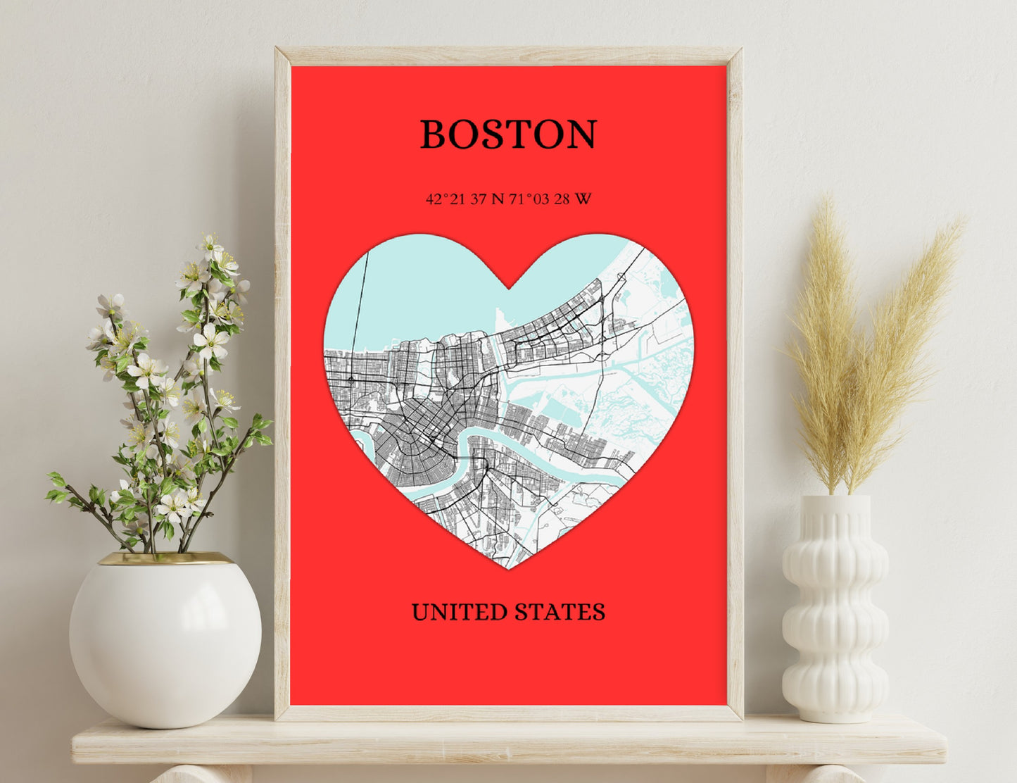 Boston city map in the shape of a heart on a red background, with the city's coordinates and location displayed below.
