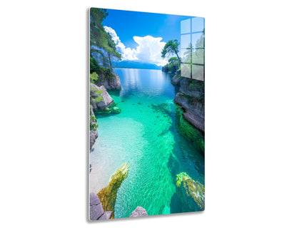 Stunning lake with crystal clear turquoise and emerald green waters, surrounded by rocky shores with pine trees, under a blue sky with fluffy white clouds reflecting on the serene water surface.
