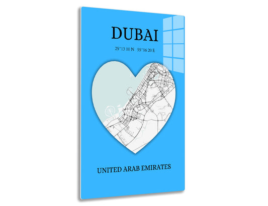 A heart-shaped map of Dubai's city streets and roads overlaid on a light blue background, with the text "DUBAI 25°13'10N 55°16'20E UNITED ARAB EMIRATES" printed below.
