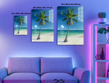 A tall palm tree stands on a pristine sandy beach against a vibrant blue sky with white clouds overlooking turquoise waters of the ocean, creating a picturesque tropical paradise scene.
