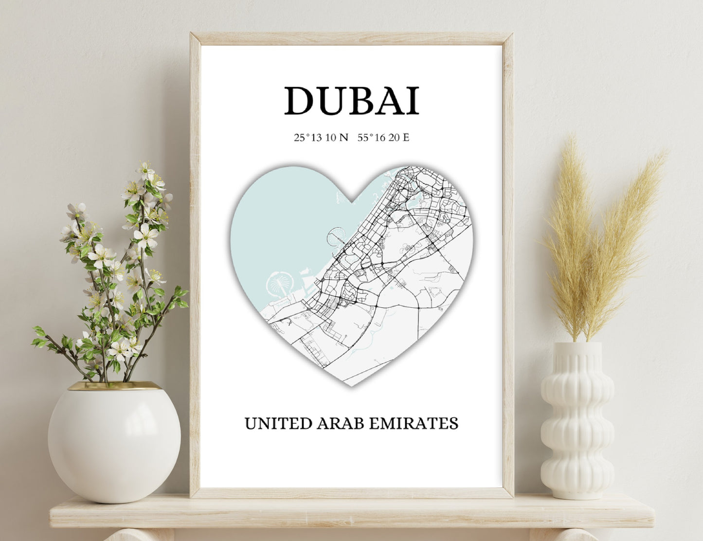 Map of Dubai in the shape of a heart, featuring major roads and landmarks against a light blue background, coordinates 25°13'10N 55°16'20E, United Arab Emirates
