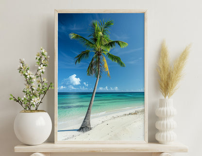 A tall, lush palm tree stands on a pristine white sandy beach, overlooking stunning turquoise waters under a blue sky with fluffy white clouds.
