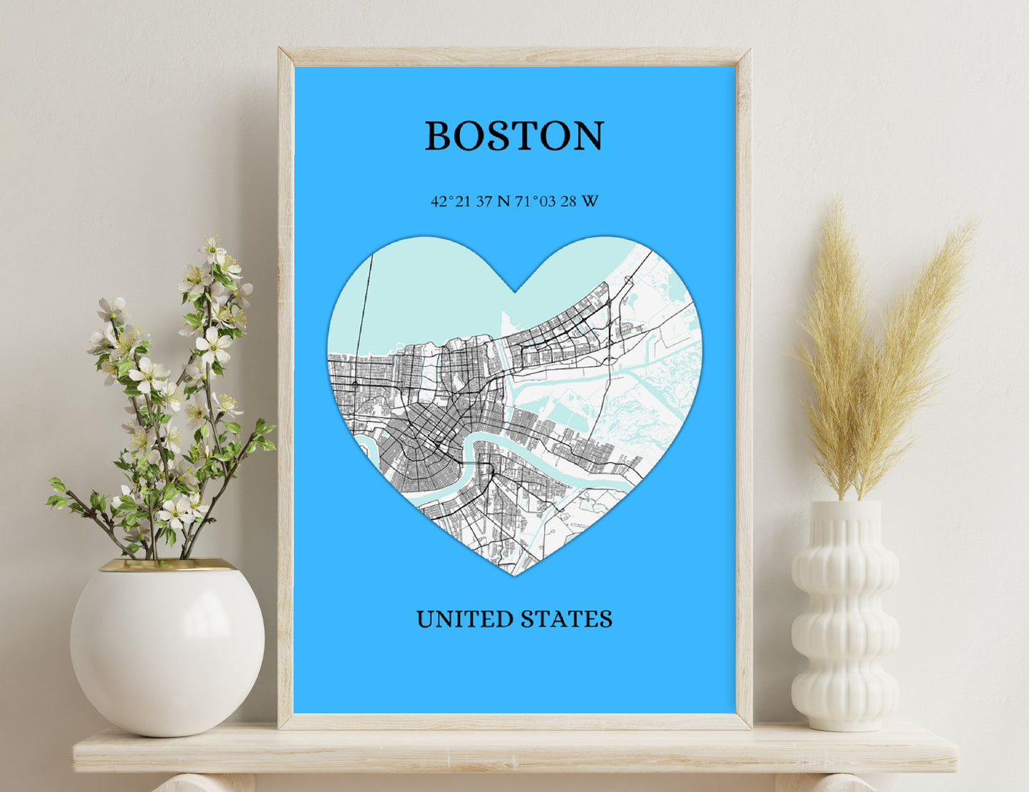 Map of Boston in a heart shape with street layout on a blue background, showing coordinates 42°21'37"N 71°03'28"W and location United States.
