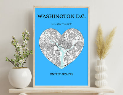 A map of Washington D.C. in the shape of a heart, showing the district's roads and waterways against a blue background, along with its geographic coordinates and the text "United States" below.
