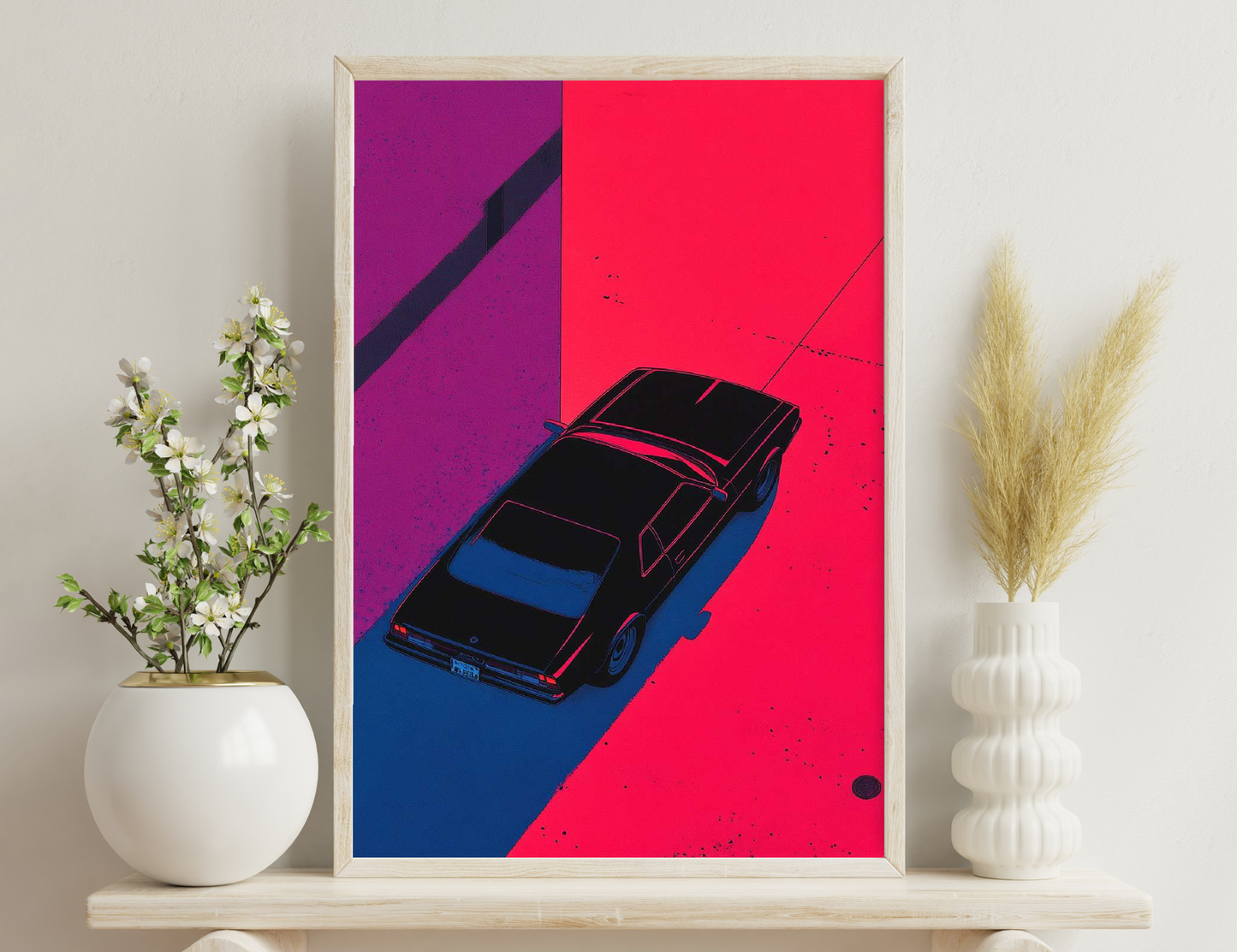 A stylized illustration of a black vintage car driving on a bold red and blue background, with abstract shapes and splatters creating a dynamic and edgy composition.
