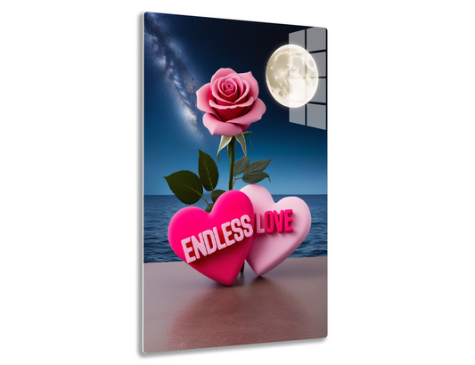 A pink rose blooming under a full moon and night sky, with two heart-shaped objects reading "Endless Love" on a beach shoreline, symbolizing romantic love.
