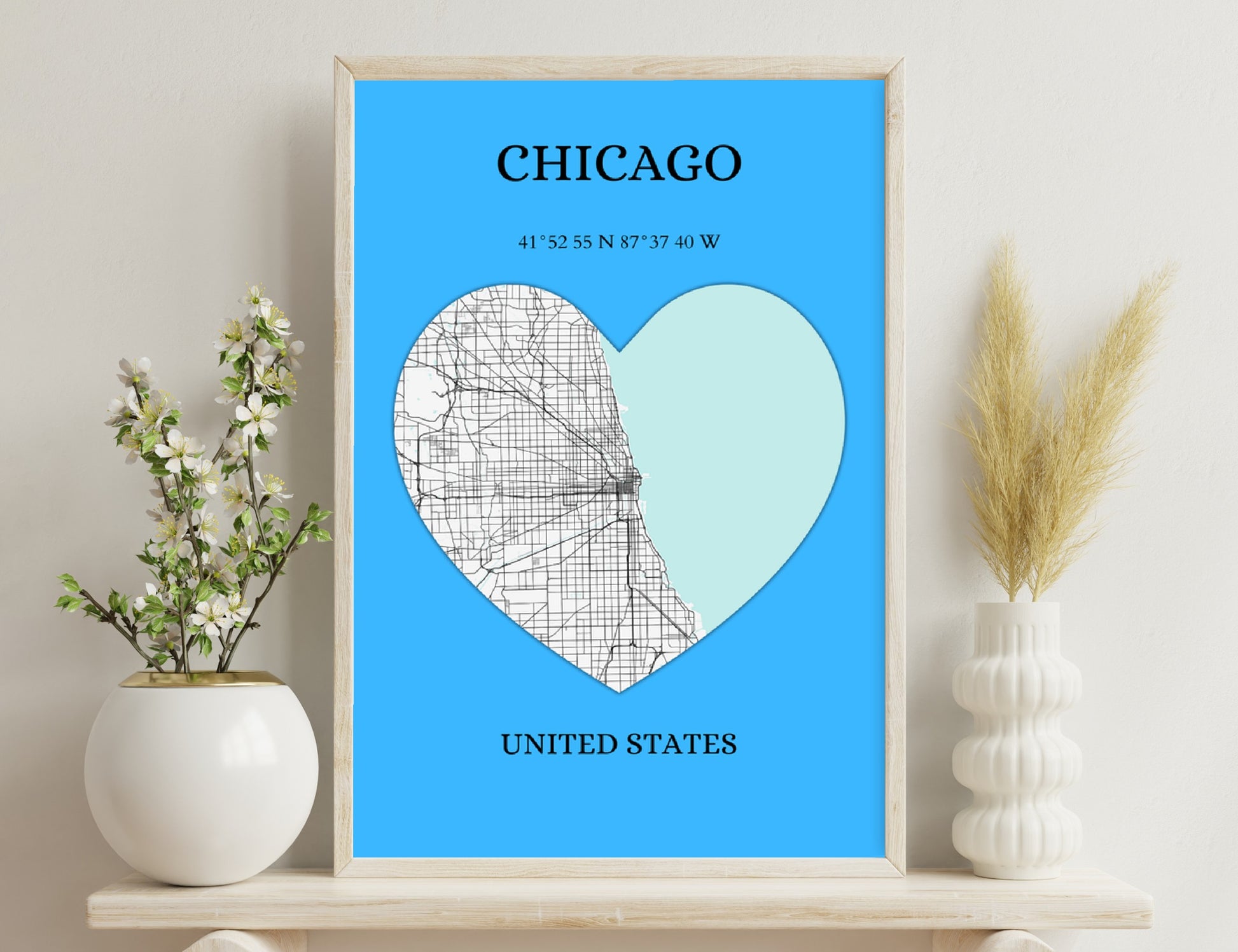 A heart-shaped graphic with a map grid overlay representing the city of Chicago, with its name, geographic coordinates, and country (United States) displayed in text, set against a blue background.
